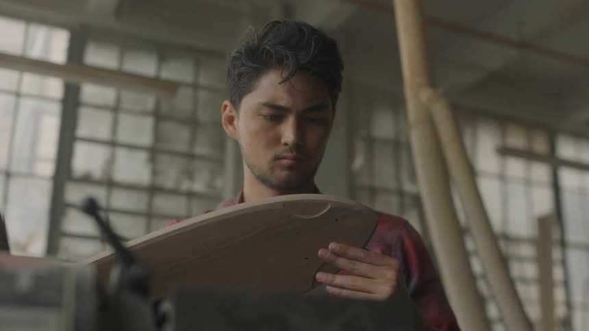 Man examining a shaped piece of wood