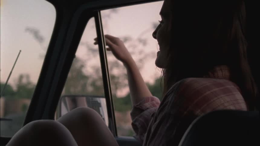 Woman sitting in the passenger seat of a moving vehicle
