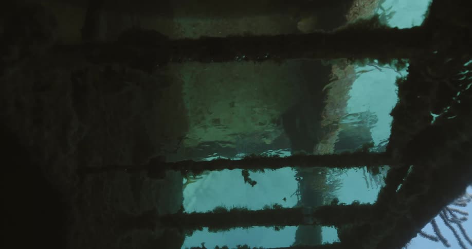 Air bubbles trapped on the ceiling of a sunken ship in the blue ocean waters