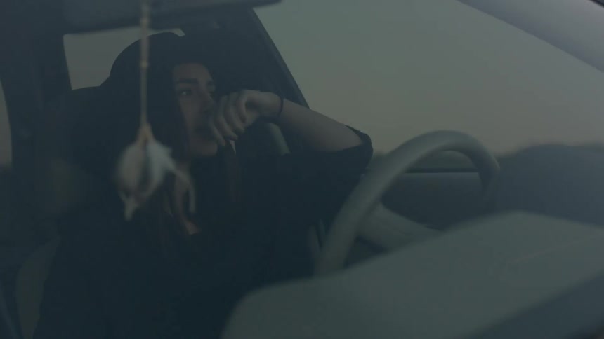 Woman sitting in the driver's seat of a car