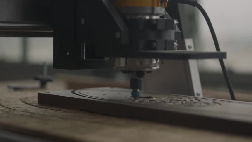 A machine is etching into wood