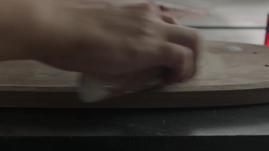 Person sanding on a piece of wood