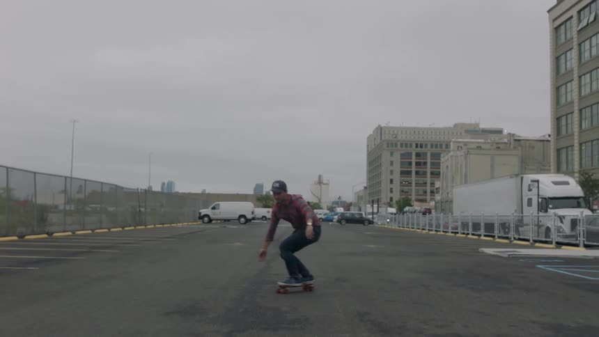 A man touches the road while skateboarding
