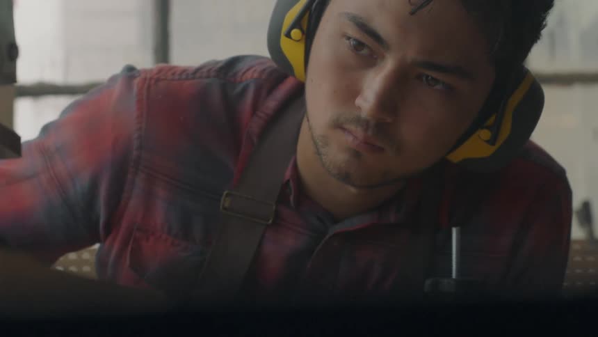 A man wearing headphones leans to his side