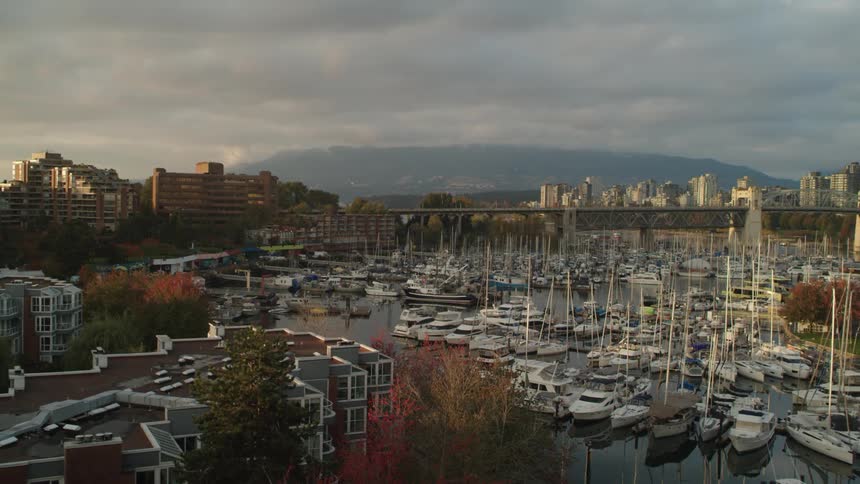 Boats fill a marina across from downtown and Burrard Bridge