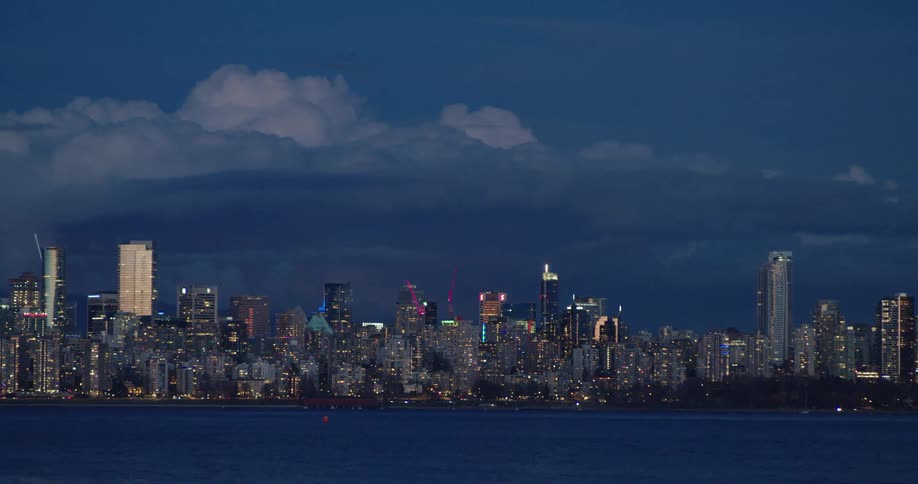 A downtown skyline is lit up as day turns to night