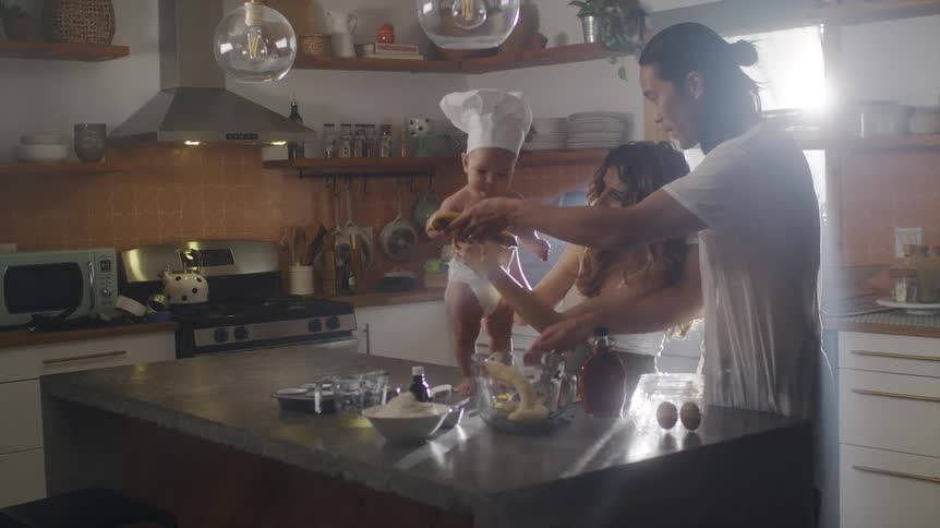 A family cook food together in the kitchen
