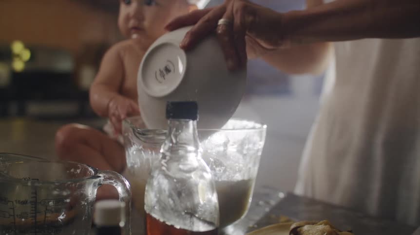 A father and son are cooking at home