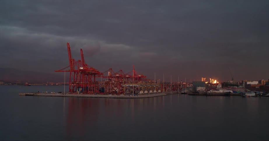 Boats move past the Port of Vancouver at sunset