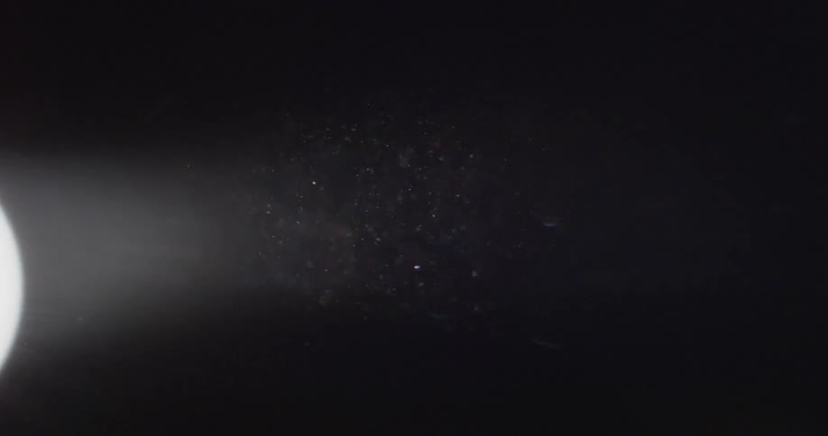 A spotlight is shining in the dark