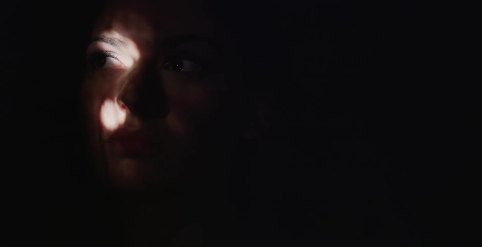 Partial illumination of a person's face through a lighted area
