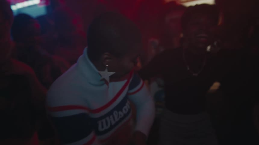 A group of people dance at a night club