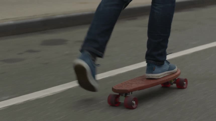 Man skateboarding down a street