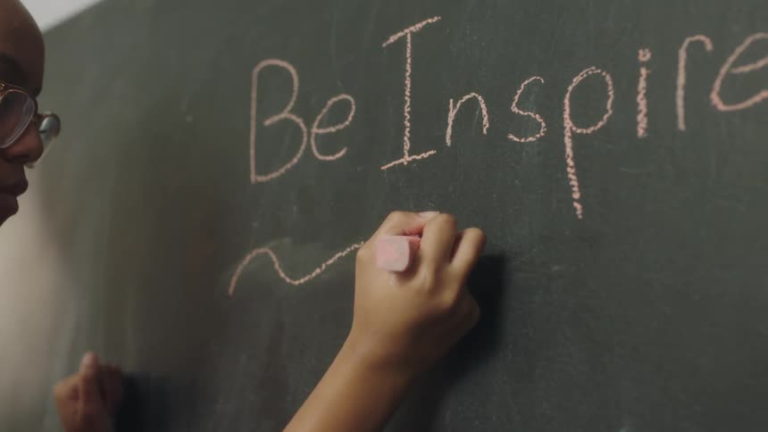 A woman writes on the chalkboard