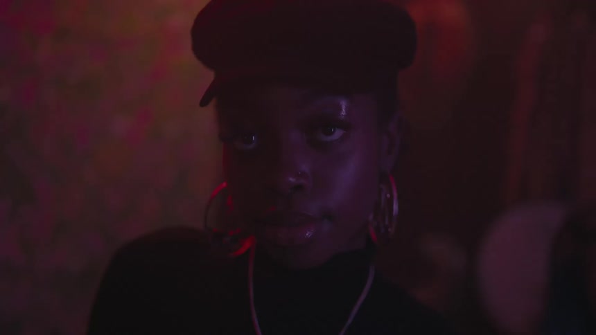 A woman wearing large earrings is starring ahead
