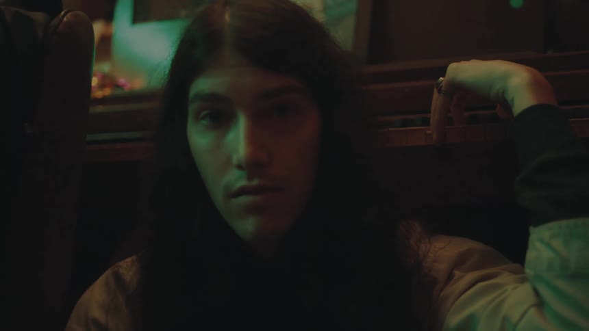 A man is sitting bored in the room