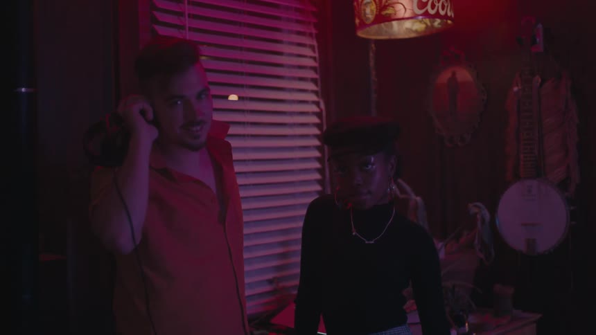 A man and woman talk at the party
