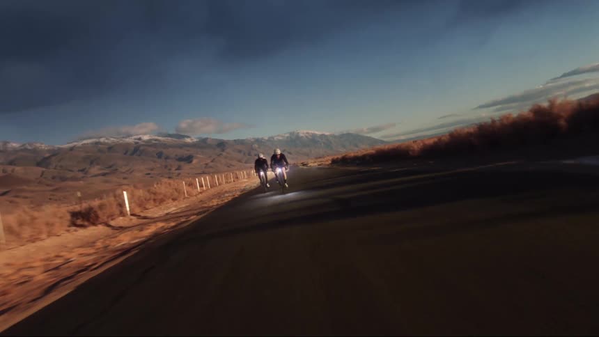Two bicycle rides race down the road