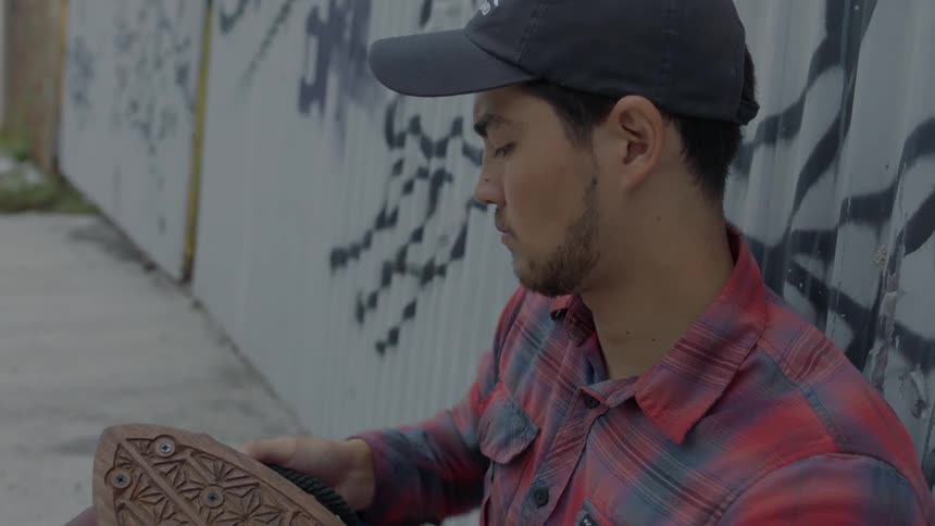 Man tightening the wheel on his skateboard
