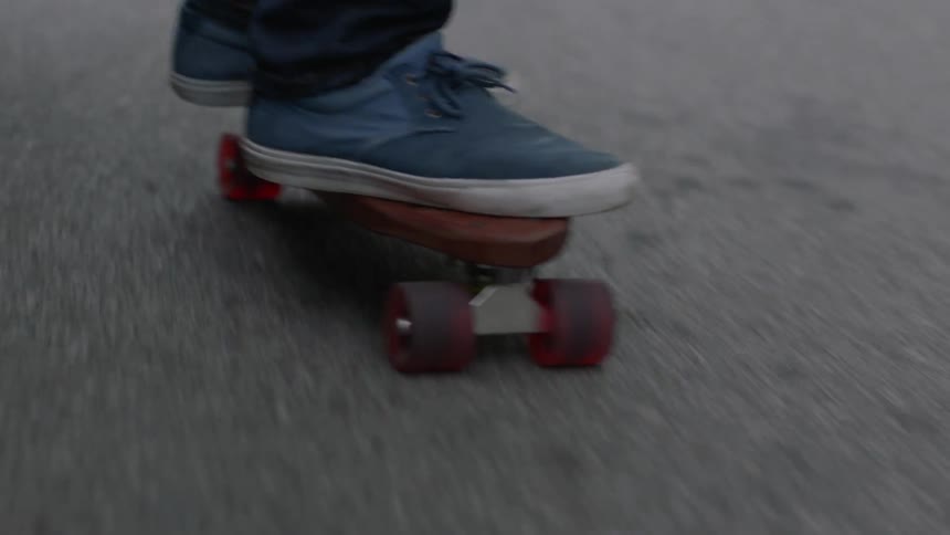 Close up of feet steering a skateboard