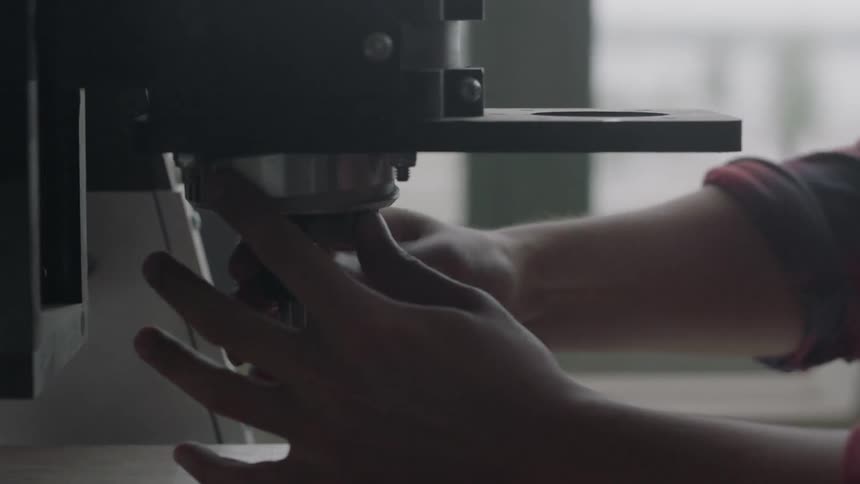 Person adjusting a drill press