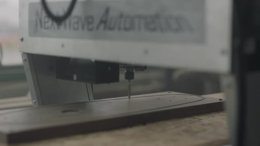 A machine is cutting into wood