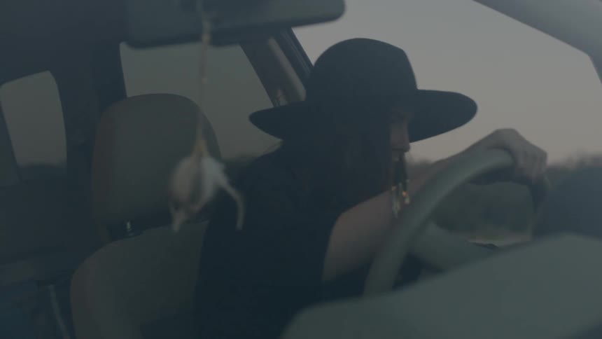 Woman getting into a car on the driver's side