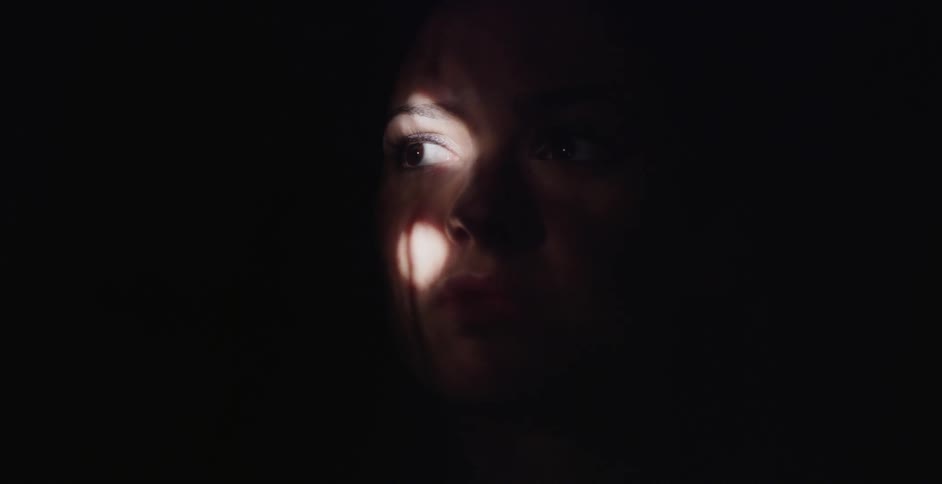 Partial illumination of a person's face through a lighted area