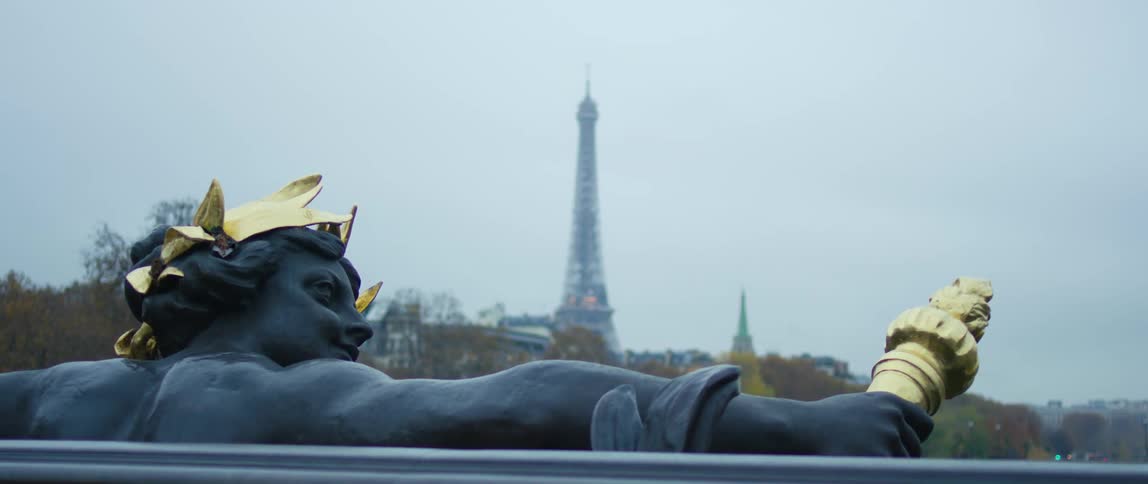A statue of a man is holding a gold rod