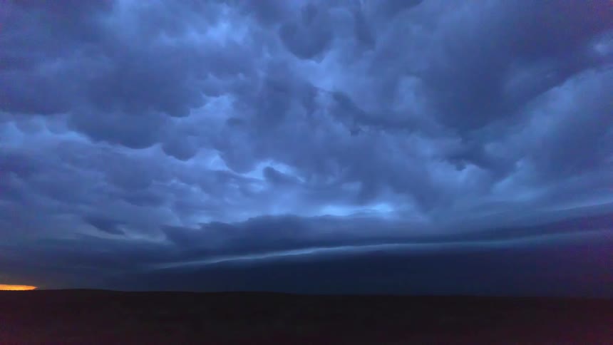Dark clouds move overhead and lightning flashes brightly in the distance