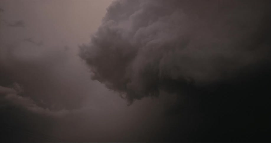Dark clouds swirl in the sky