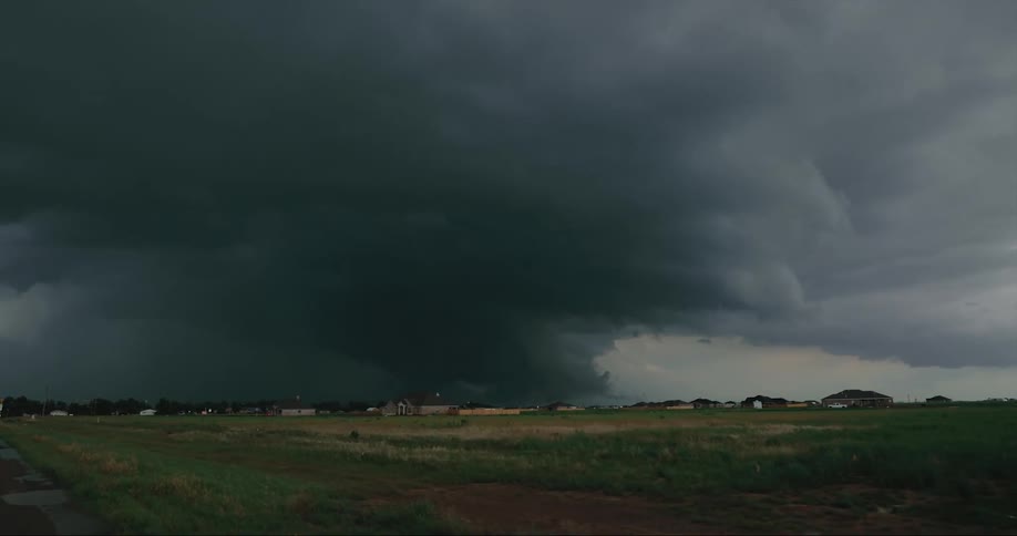 Dark storm front sits on horizon near neighborhood