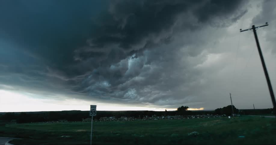 Dark storm clouds over a grassland in a rural area