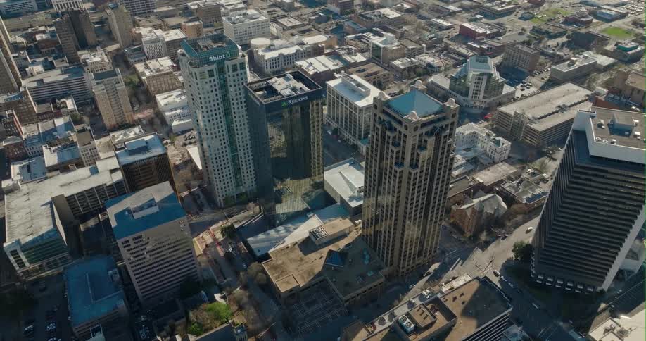 Aerial view of buildings in a downtown city is displayed