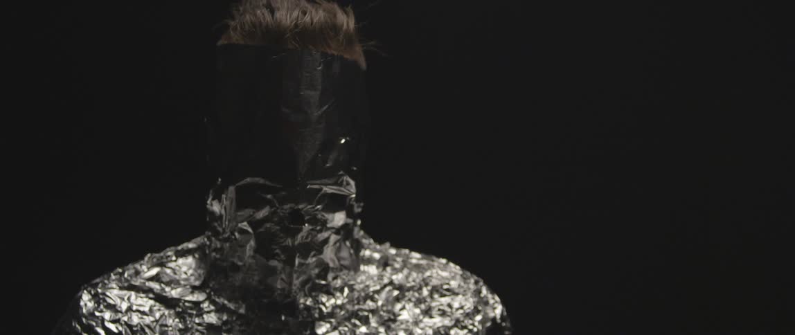 A blonde person wrapped up in tinfoil