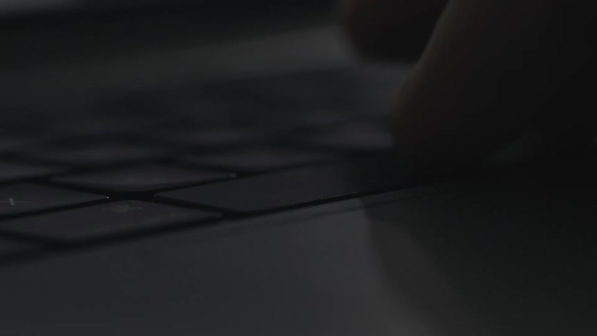 A person presses the space key on their laptop keyboard