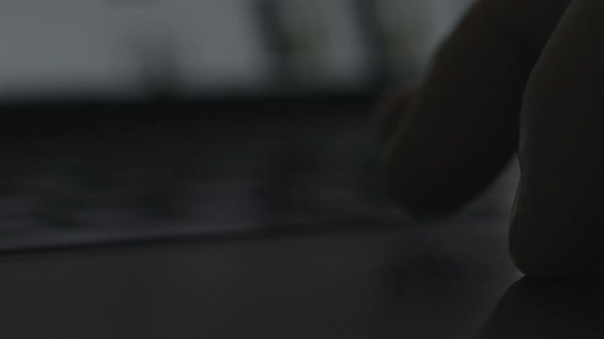 Someone is moving their fingers across the touch pad on a laptop computer
