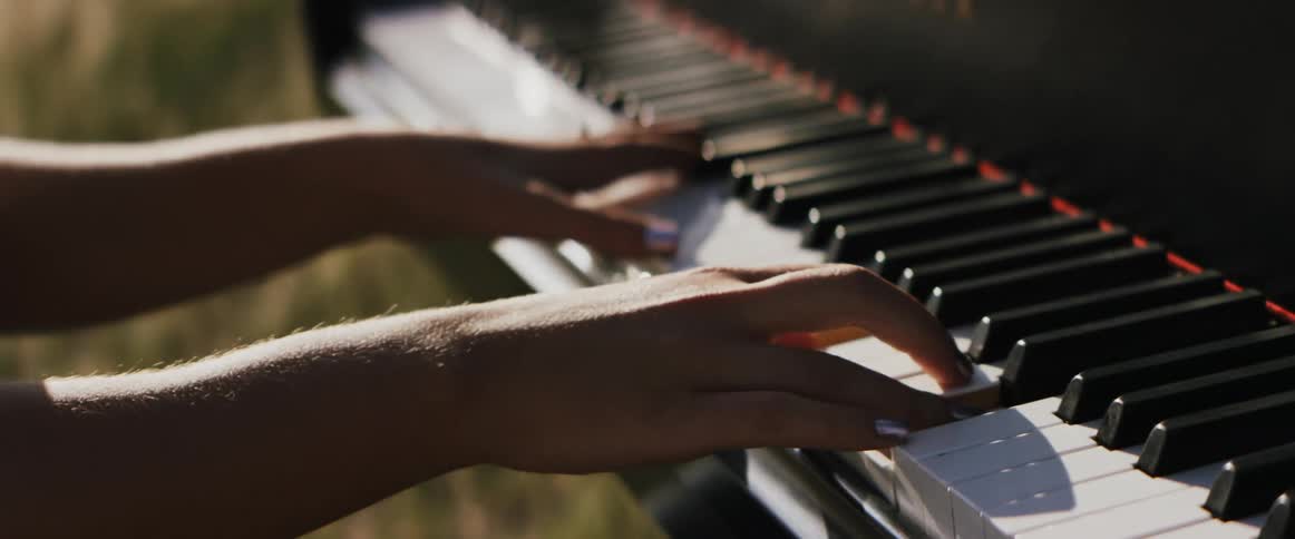 Woman plays piano in the field