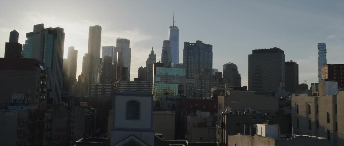 Sun goes down behind skyscrapers and office buildings in the city