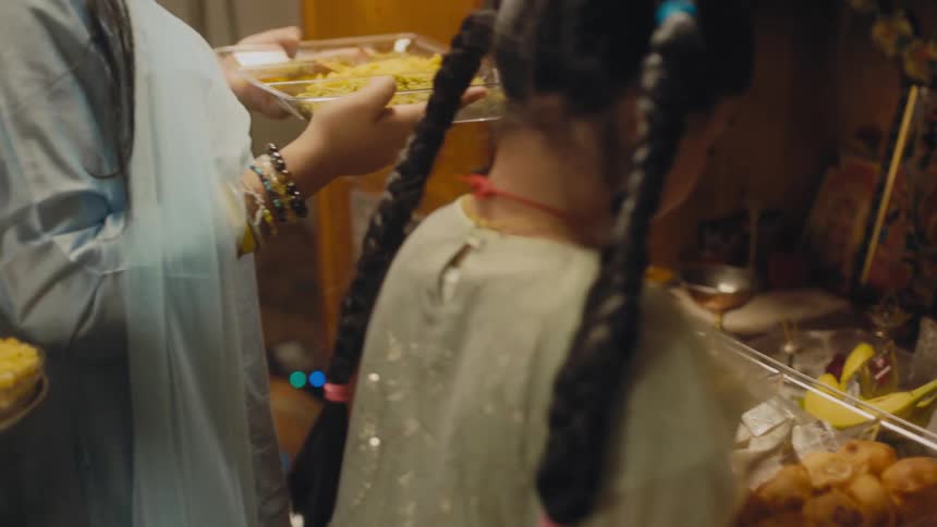 A family bringing food to an altar