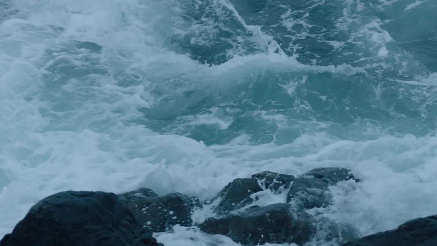 Ocean waves break against the rocks on the coast