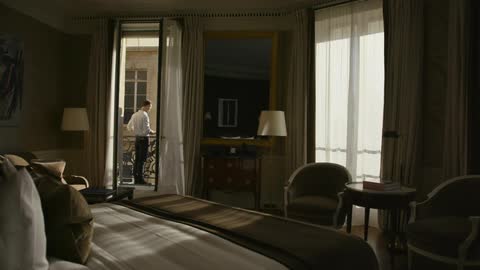 Man standing outside the doorway of a bedroom