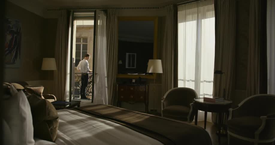 Man standing outside the doorway of a bedroom