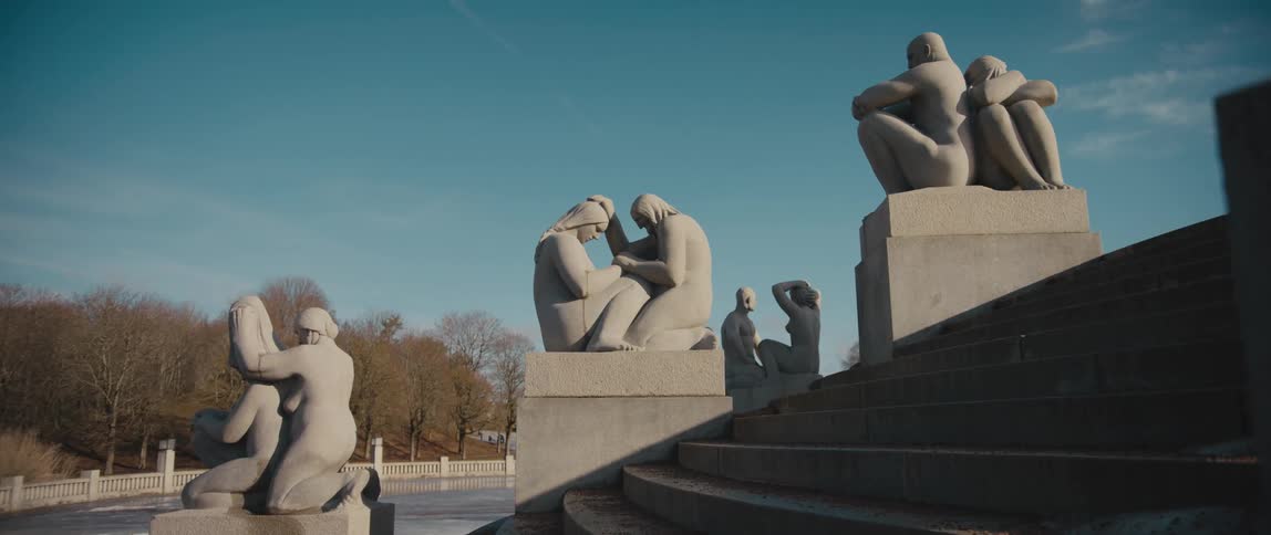 Human figure sculptures by Gustav Vigeland flank the steps leading up to the Monolith in Frogner Park, Oslo, Norway.