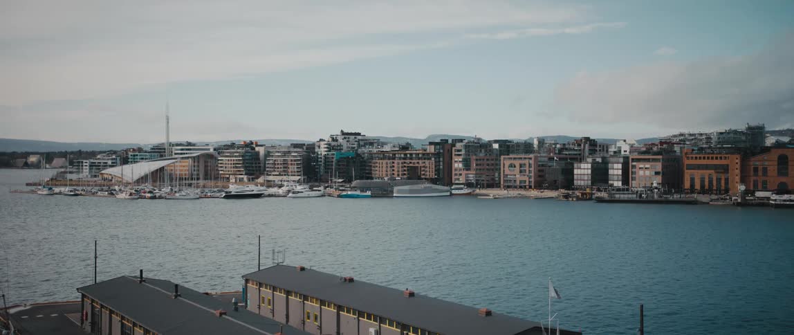 A piece of the Oslo, Norway skyline as viewed from Oslo harbor at the Aker Brygge and Tjuvholmen neighbourhoods.