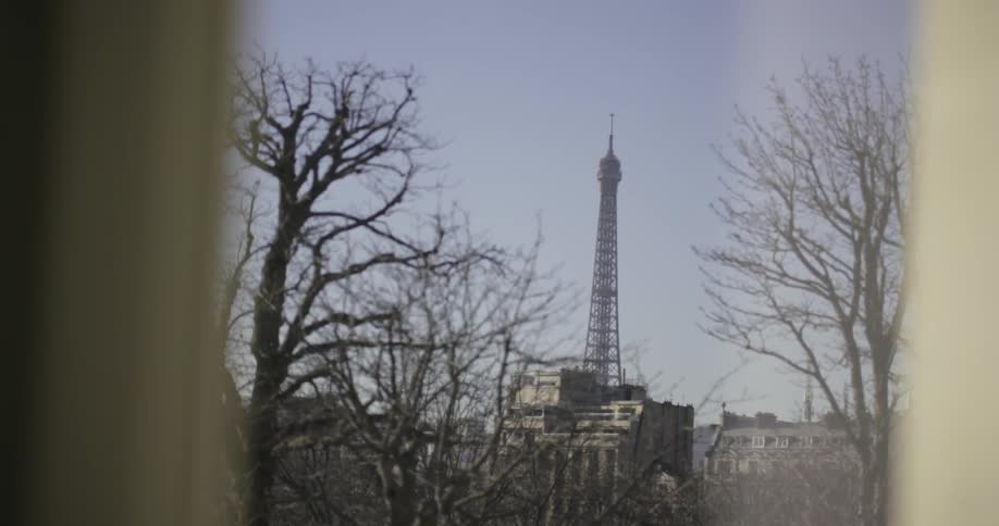 Looking out of a window at the Eiffel tower