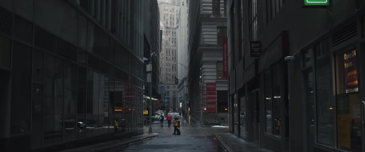 Pedestrians walk along the streets and alleyways between tall buildings in a metropolis during the day
