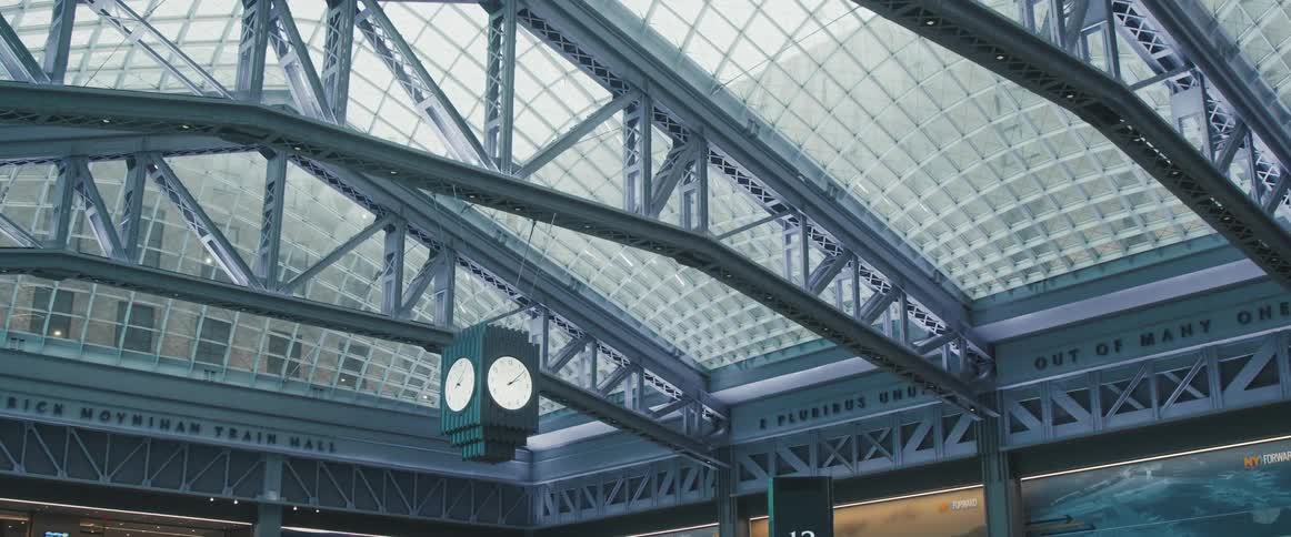 The glass and beam ceiling of the moynihan train hall station in new york