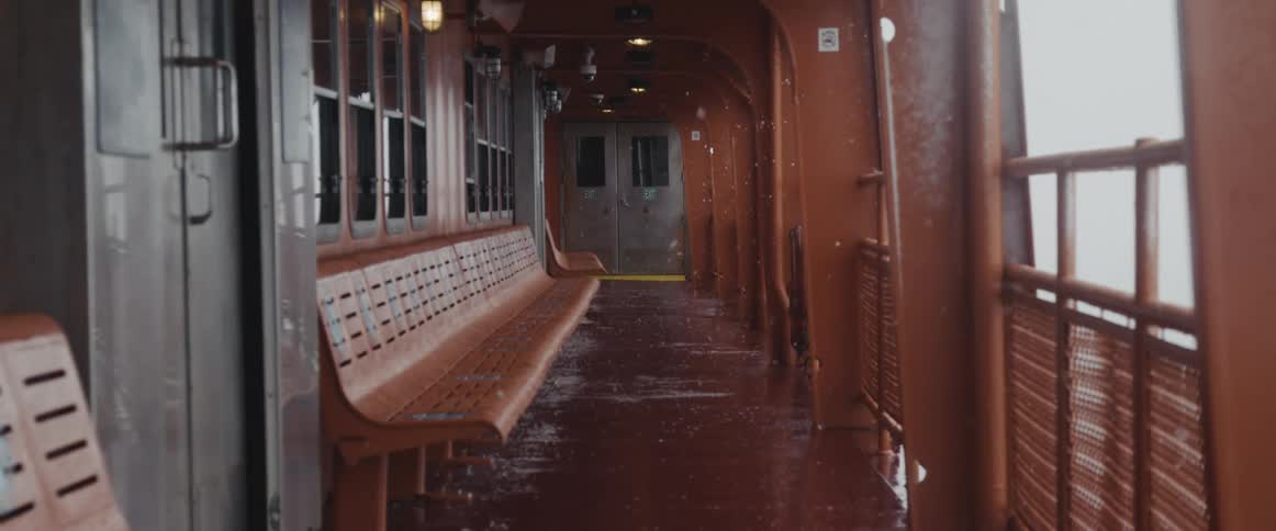 Snow falling on the outdoor deck of a ship