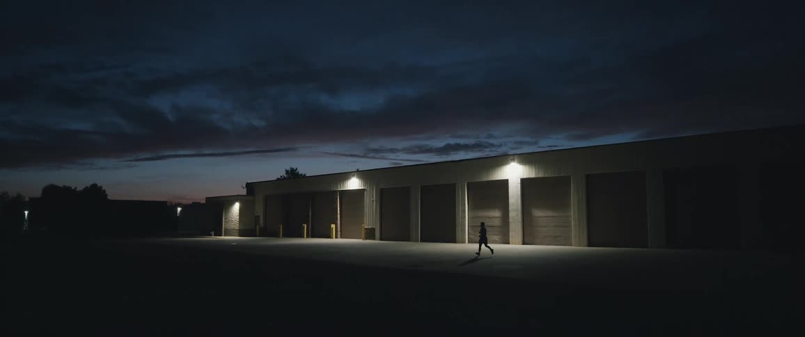 A man runs through the parking lot